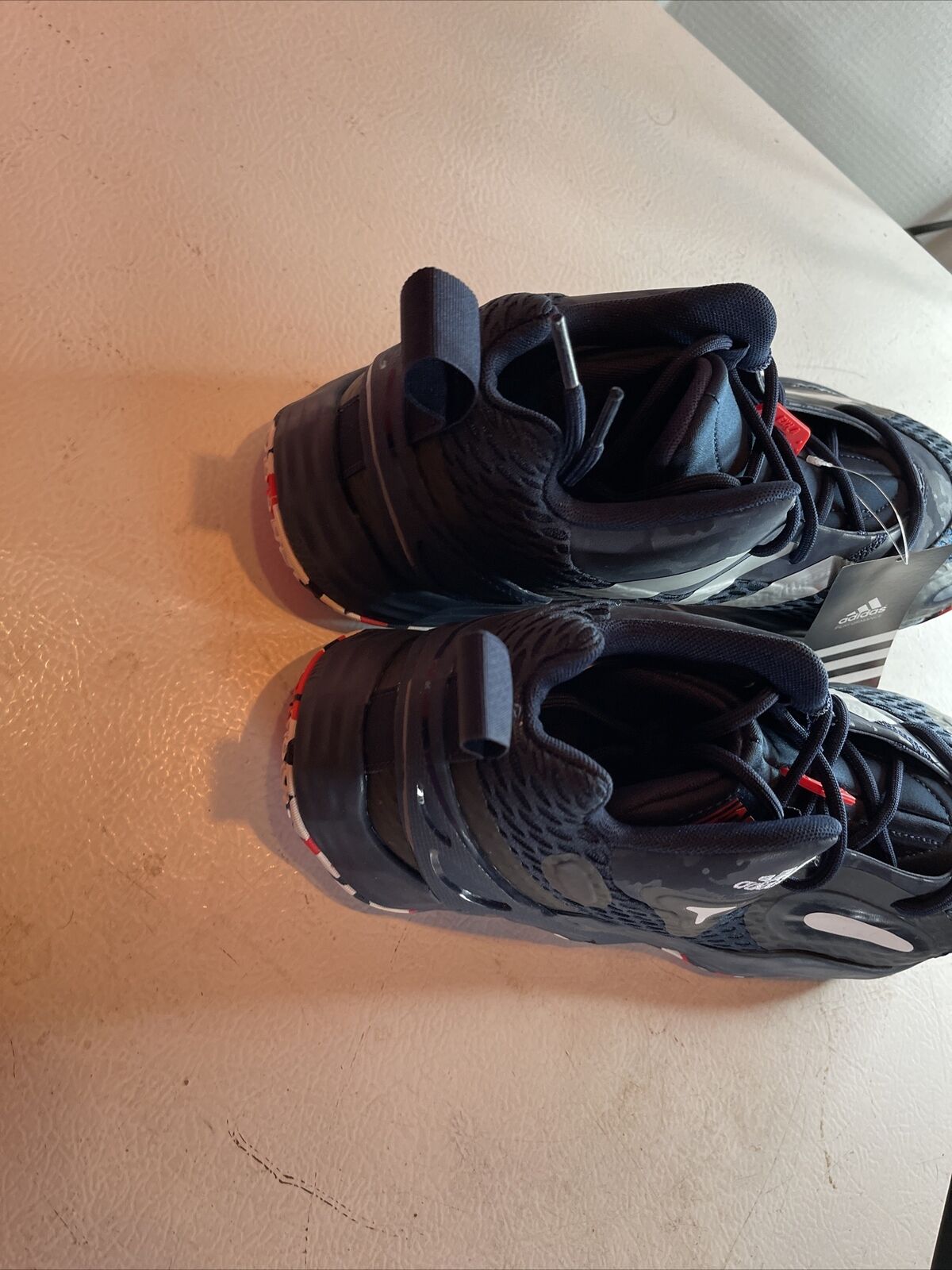 Top view of black Adidas SM Exhibit A Team USA basketball shoes with red accents and pull tabs