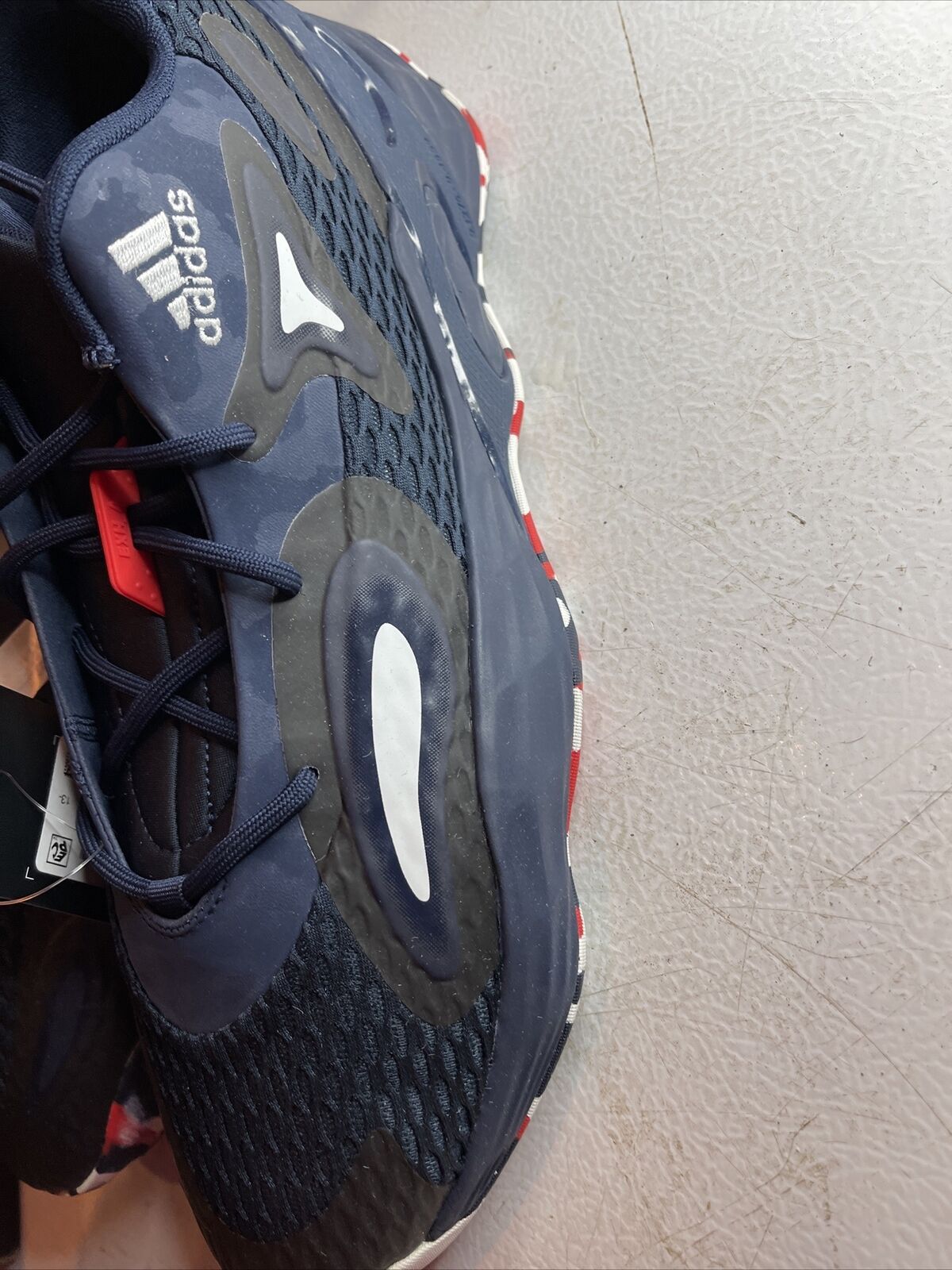 Adidas SM Exhibit A Team USA shoes in navy blue with white and red accents and mesh upper design