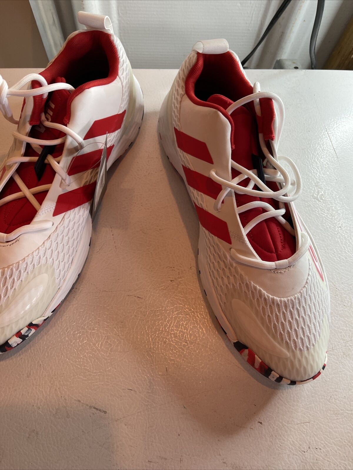 White and red Adidas SM Exhibit A Team USA sneakers with mesh design and lace-up closure
