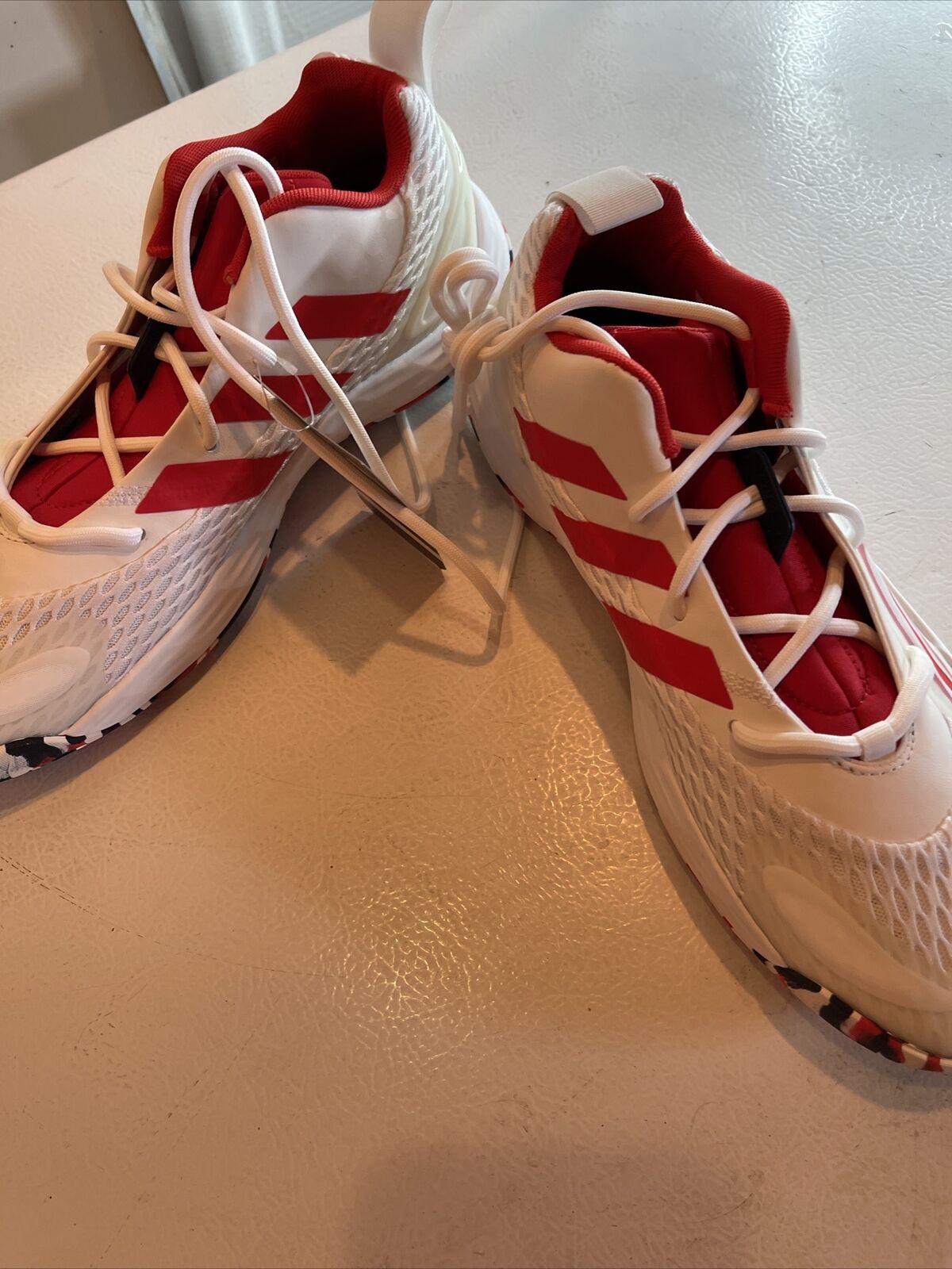 Adidas SM Exhibit A Team USA sneakers in white with red accents and laces on a light surface