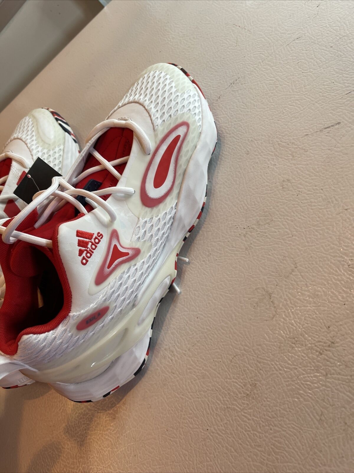 White and red Adidas SM Exhibit A Team USA sneakers with breathable mesh and cushioned sole