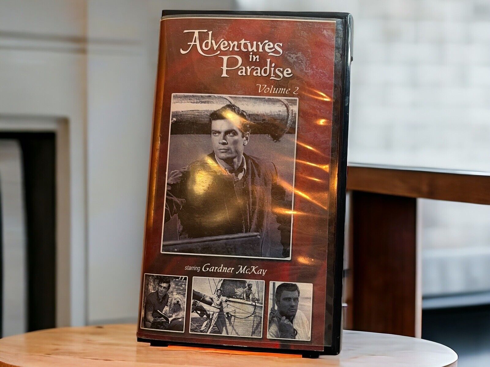 Adventures in Paradise Volume 2 VHS tape with vintage cover featuring Gardner McKay on wooden table