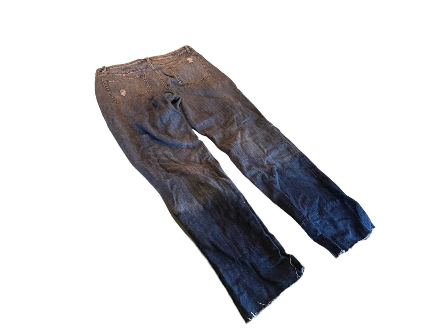 AFRM distressed jeans with faded and worn detailing in dark blue and brown shades