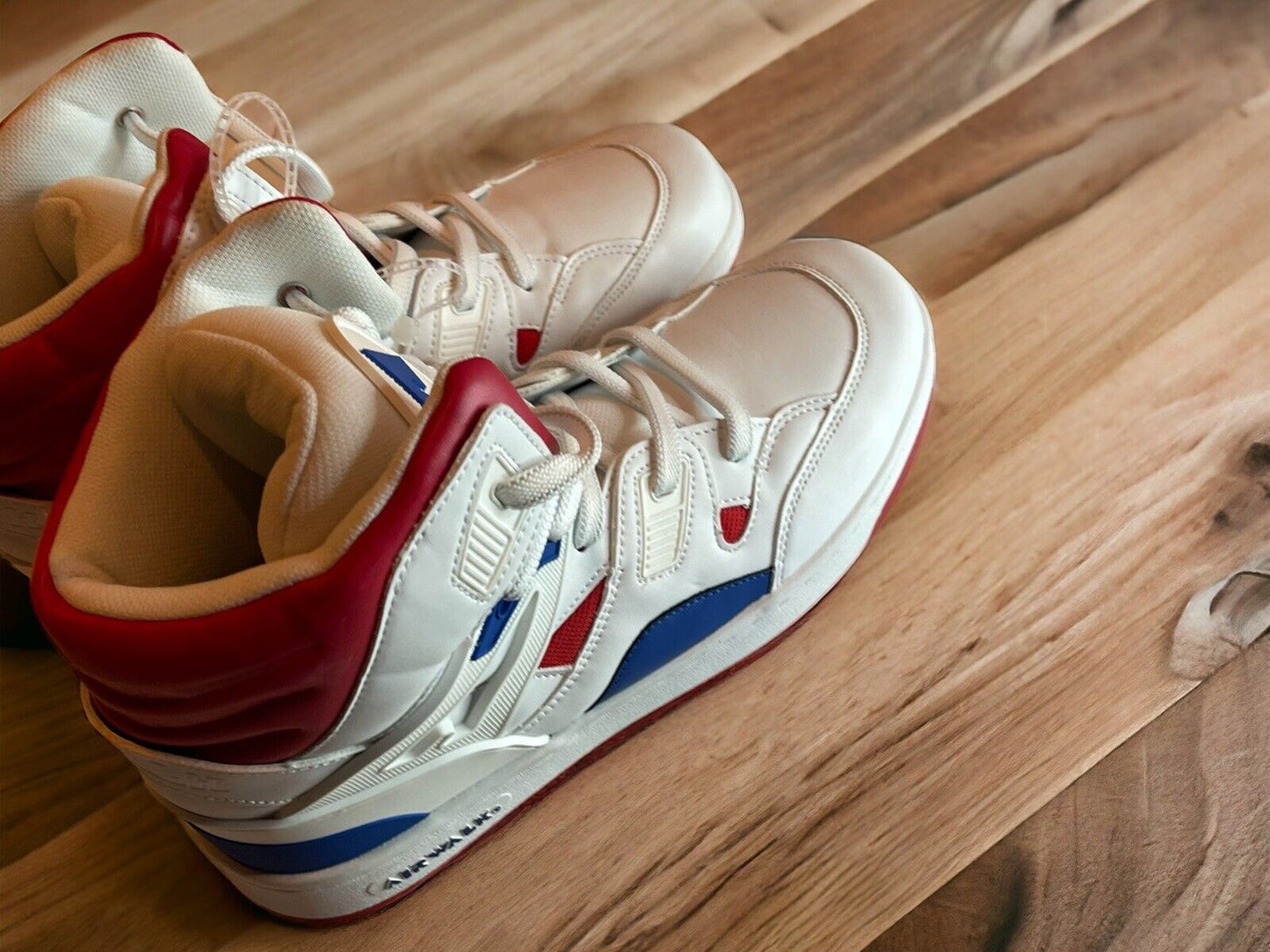 White and red Airwalk men’s sneakers size 10.5 with blue accents on wooden floor