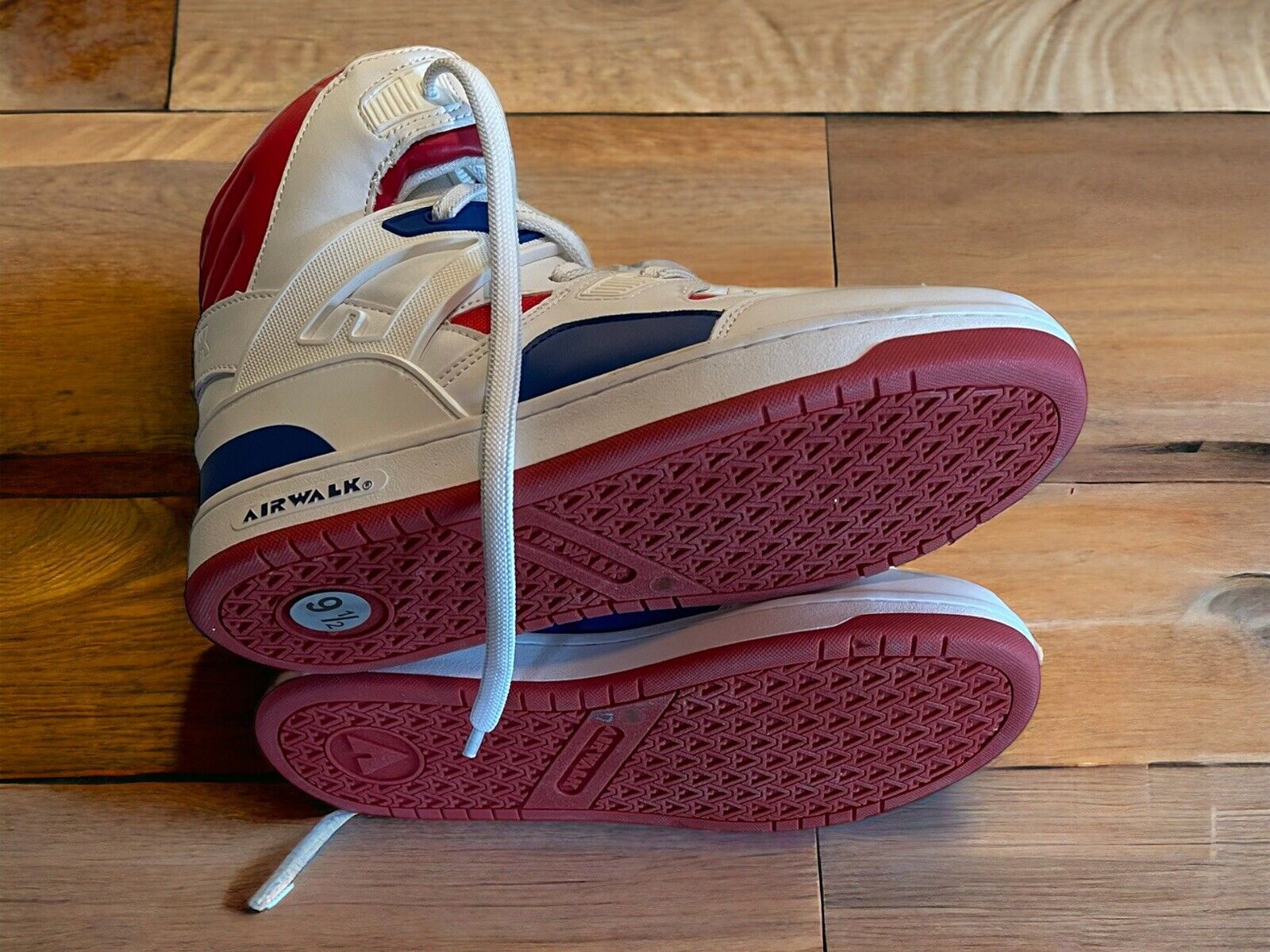 Airwalk men’s sneakers size 9.5 in white red and navy blue with detailed sole view on wooden floor