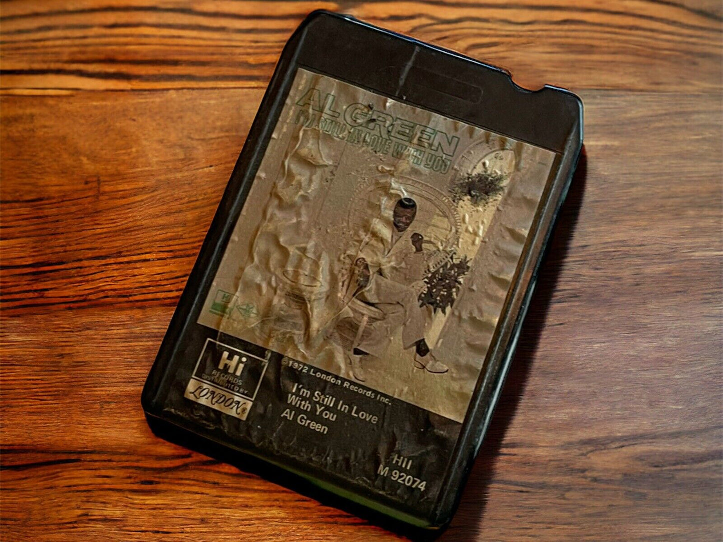 Vintage Al Green 8 track tape with worn label resting on wooden surface