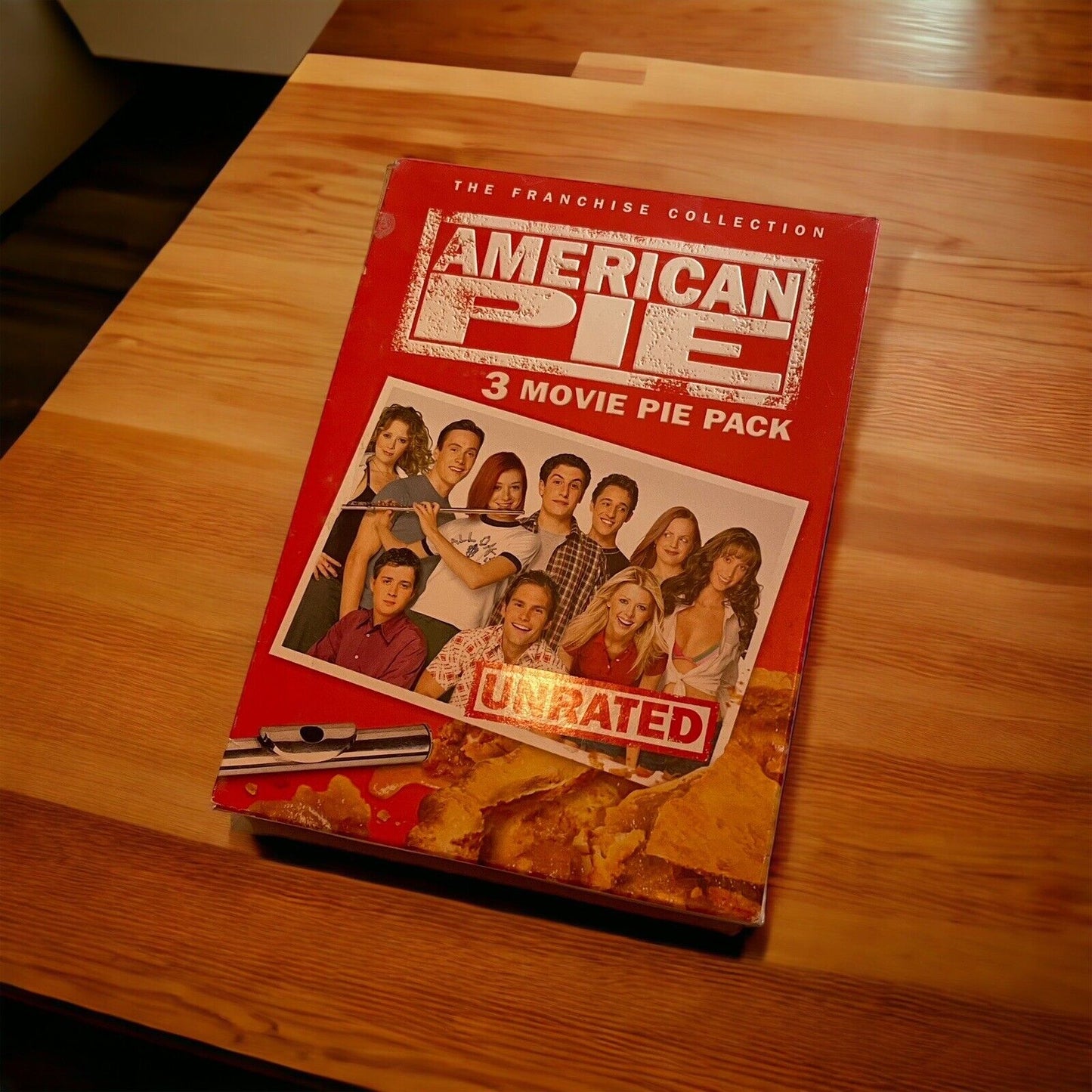 American Pie unrated movie collection 3 movie pie pack DVD box set on wooden table
