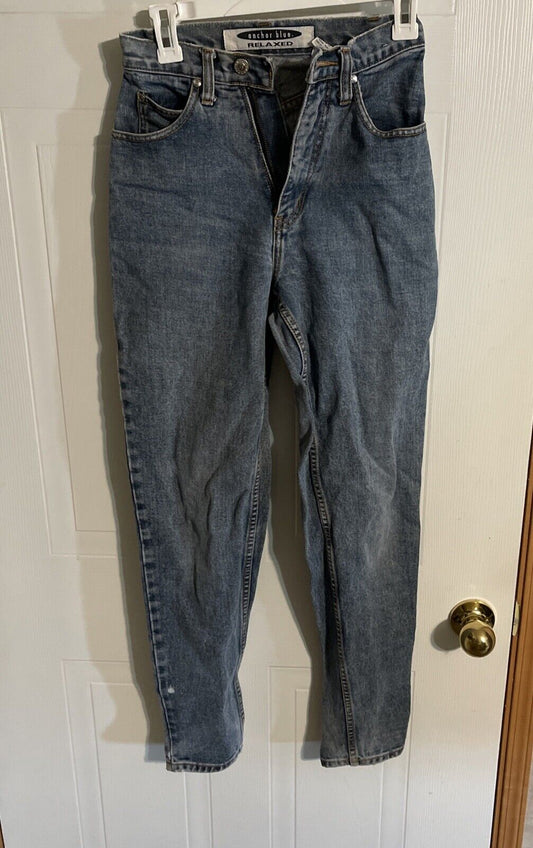 Anchor Blue relaxed fit jeans in classic blue denim hanging on white door