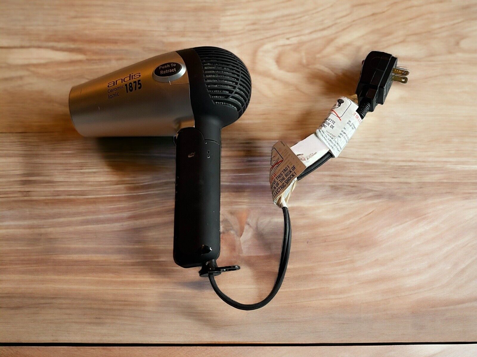 Andis 1875 hair dryer for parts with black handle and silver body showing power cord and plug