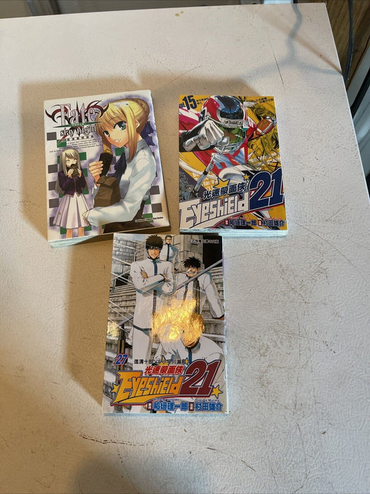Anime book lot for sale featuring manga volumes with colorful illustrated covers on a white surface