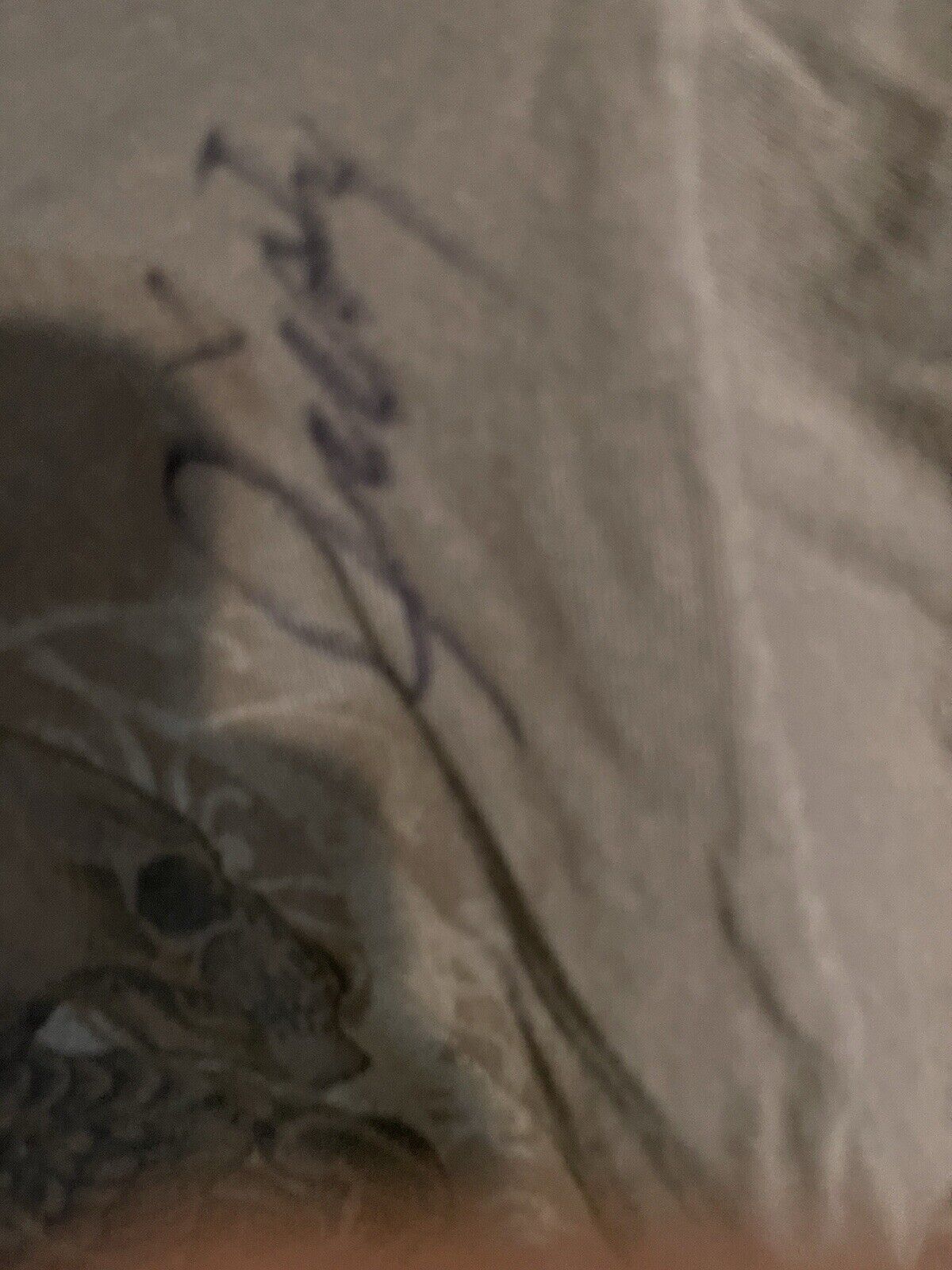 Close-up of Apostasy Eternal Agony autographed shirt showing signature and fabric texture