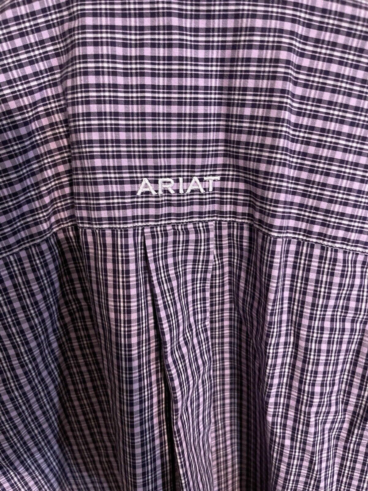 Close-up of a purple and black plaid Ariat wrinkle free shirt with embroidered Ariat logo