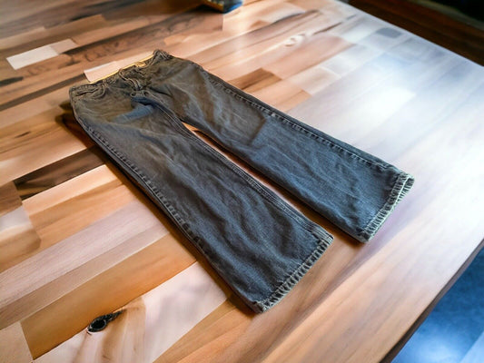 Ariat M4 jeans 33x34 laid flat on wooden table showing full length and casual fit style