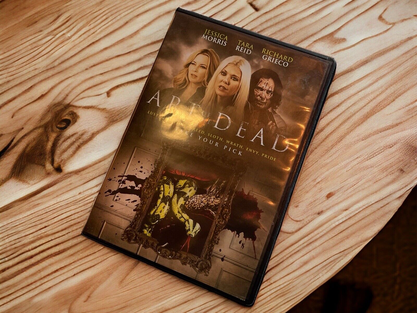 Art of the Dead DVD featuring Jessica Morris, Tara Reid, and Richard Grieco on wooden surface