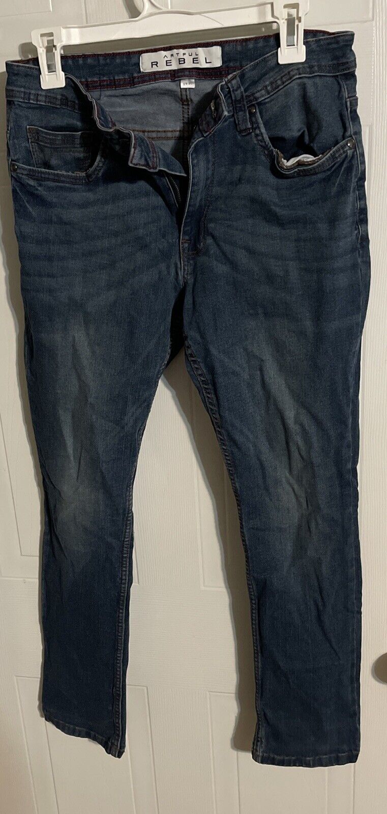Dark wash denim Artful Rebel jeans 32x30 hanging on white hanger with front view