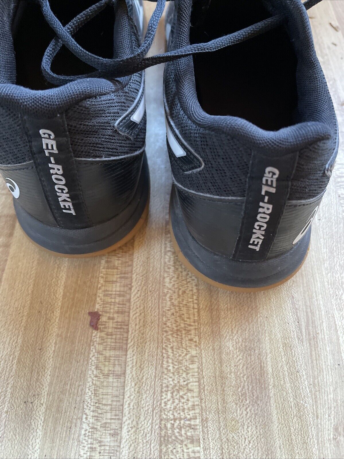 Rear view of black ASICS Gel Rocket size 9.5 basketball shoes on wooden floor
