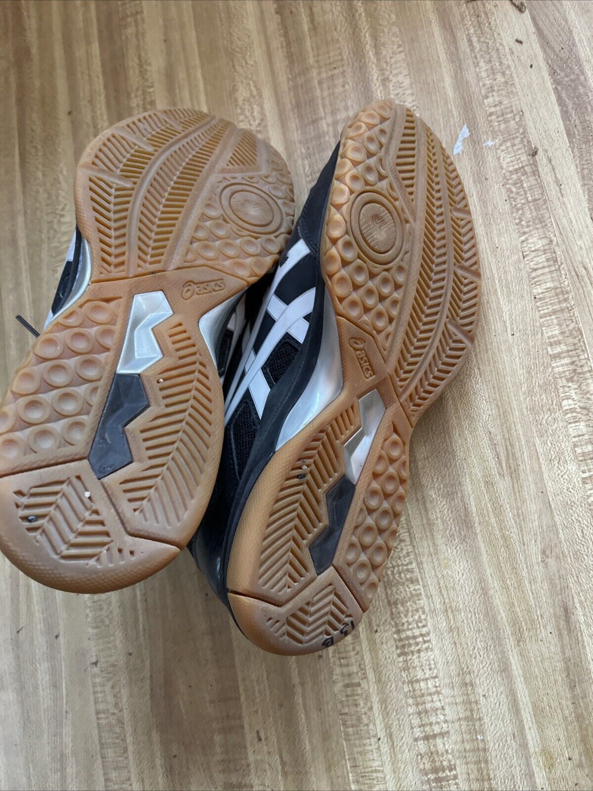 Bottom view of ASICS Gel Rocket size 9.5 shoes showing gum rubber sole tread pattern