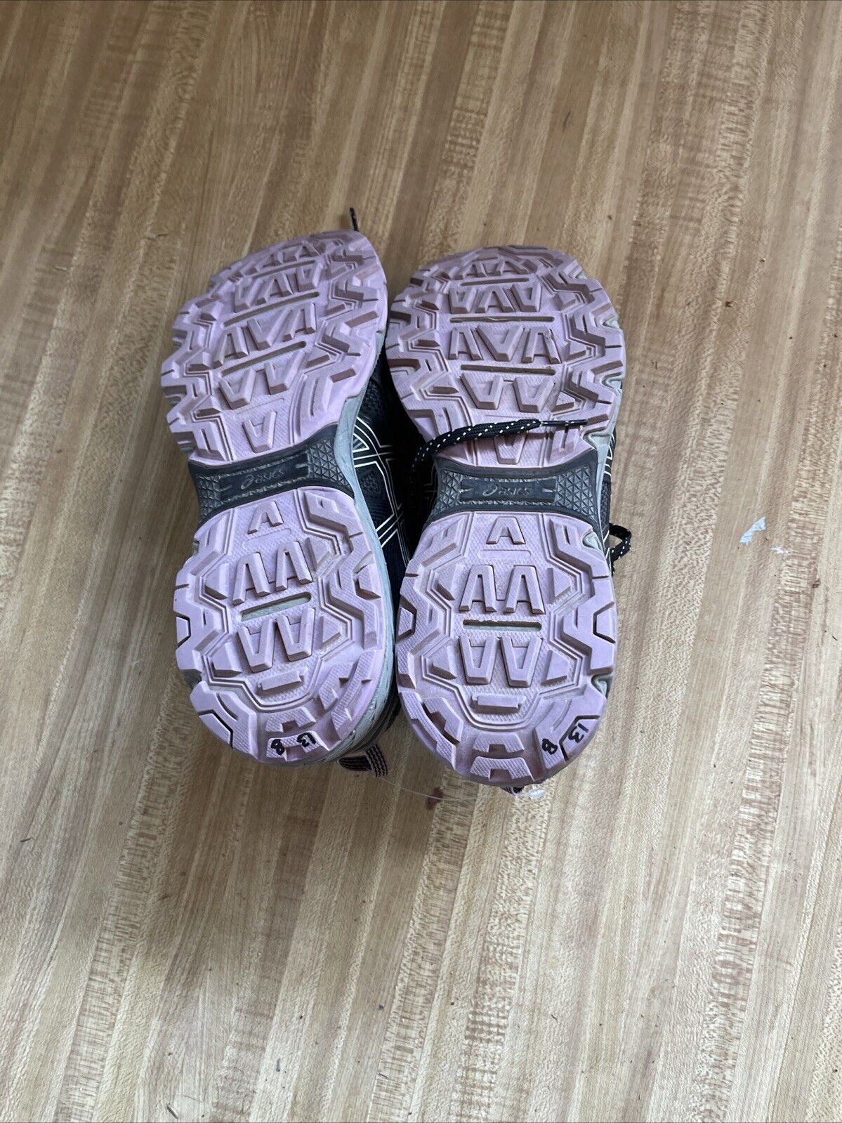 Bottom view of ASICS Gel Venture 8 women’s wide trail running shoes showing pink soles with textured tread