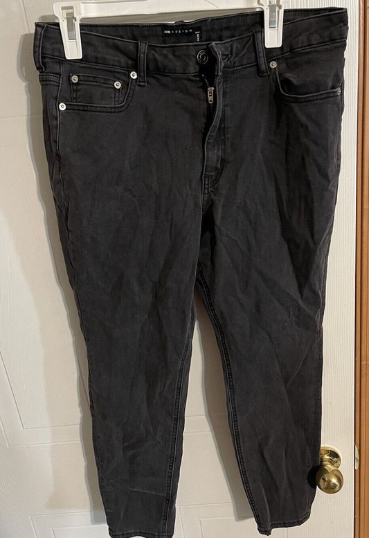 Black ASOS Design jeans men hanging on a hanger with front zipper and pockets visible