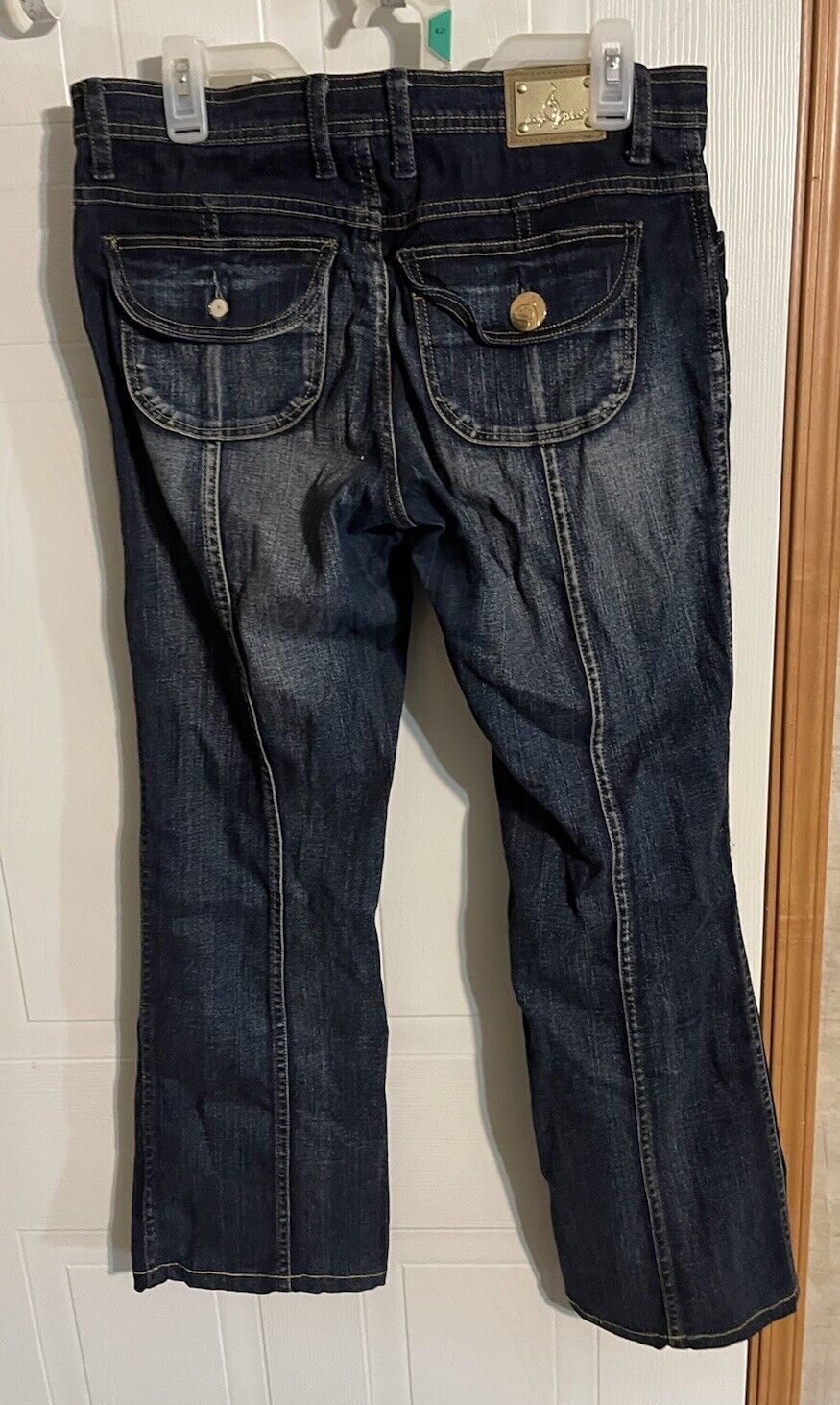 Dark wash Baby Phat Jeans for women with double back flap pockets and gold button details