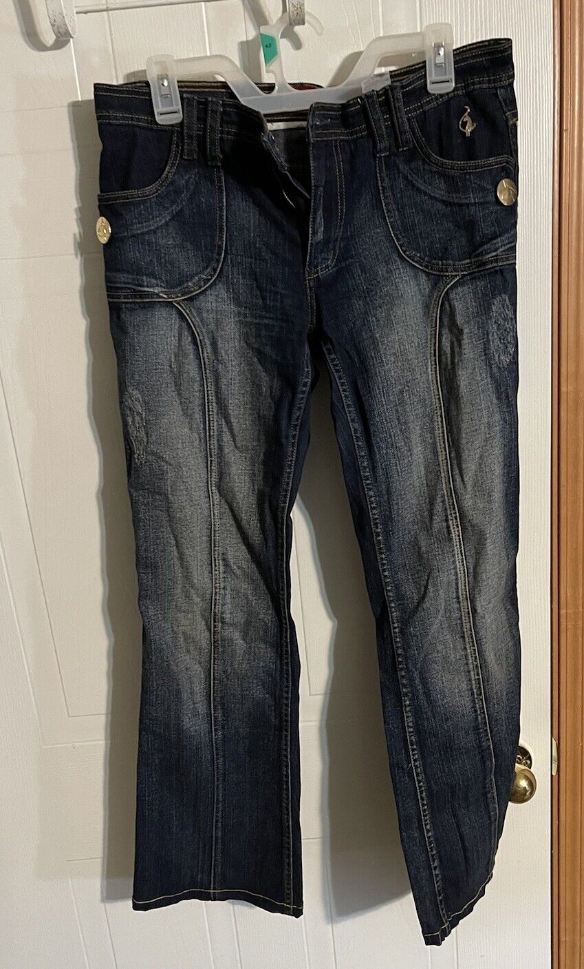 Dark wash Baby Phat Jeans for women with front pockets and button details hanging on clear hangers