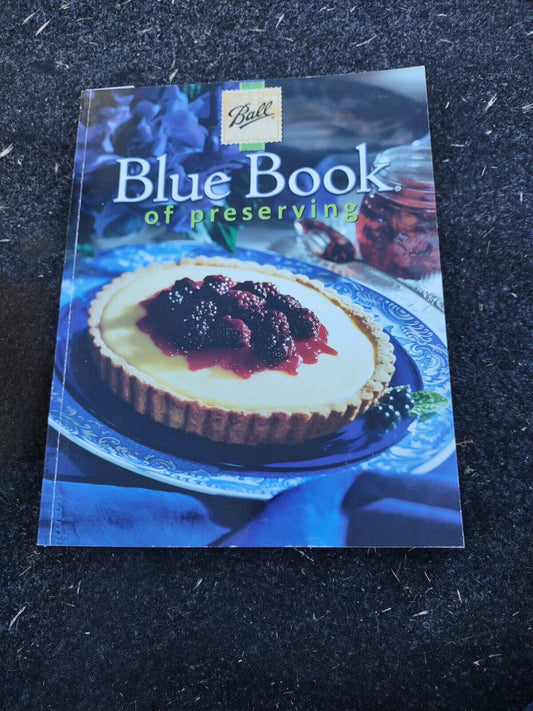 Ball Blue Book canning guide showing a tart with berries on a blue plate on the cover