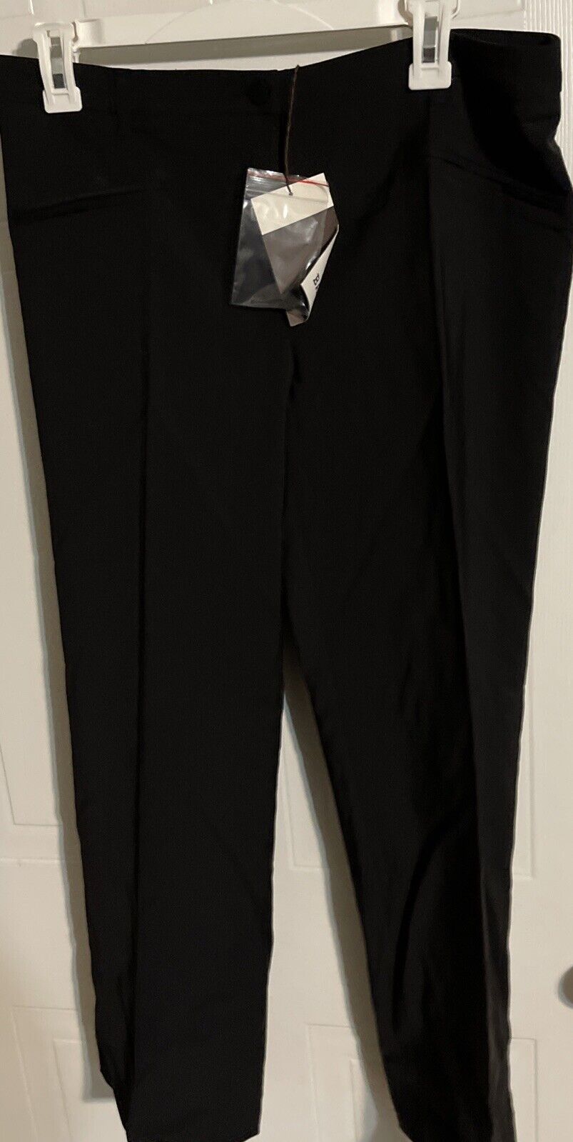Bally women's black suit pants hanging on white hanger with tag attached