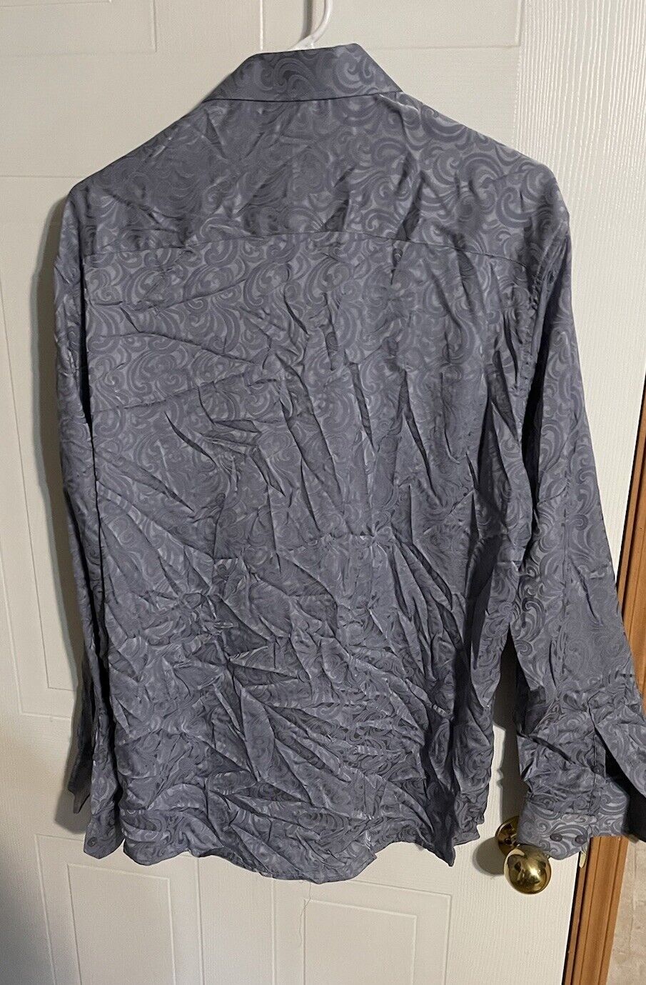 Back view of Barabas men's shirt XL in gray with subtle swirling pattern hanging on a door