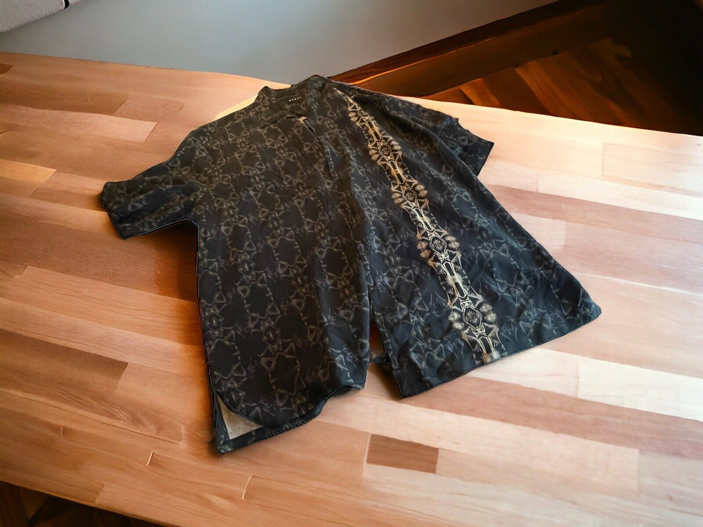Baracuta silk shirt XL in dark color with intricate patterns laid flat on wooden table