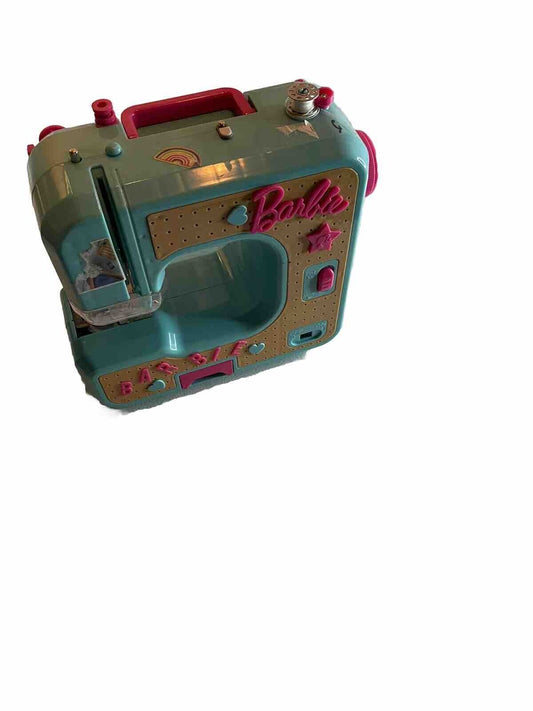 Blue and pink Barbie sewing machine toy with decorative details and compact design