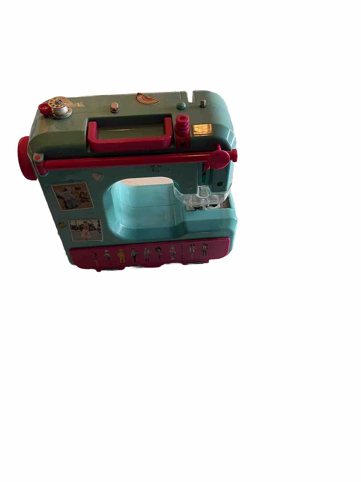 Colorful Barbie sewing machine toy in teal and pink with detailed buttons and accessories