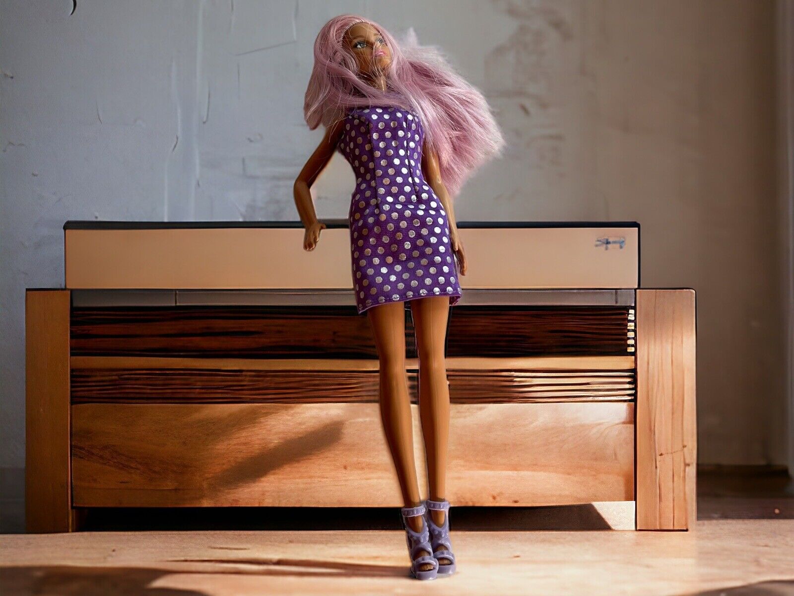 Barbie doll with purple dress featuring white polka dots and matching purple high-heeled shoes