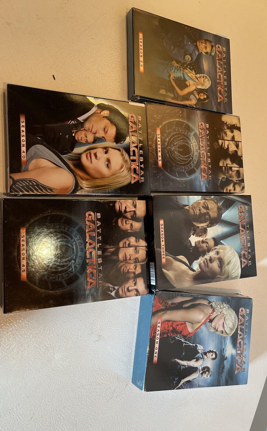 Battlestar Galactica DVD set featuring multiple season box sets with character images on each cover