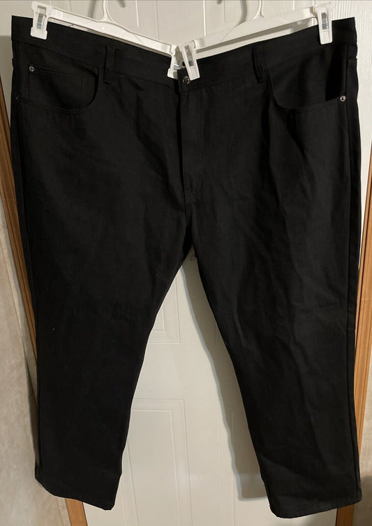 Big and tall black jeans men hanging on white hangers in front of a door