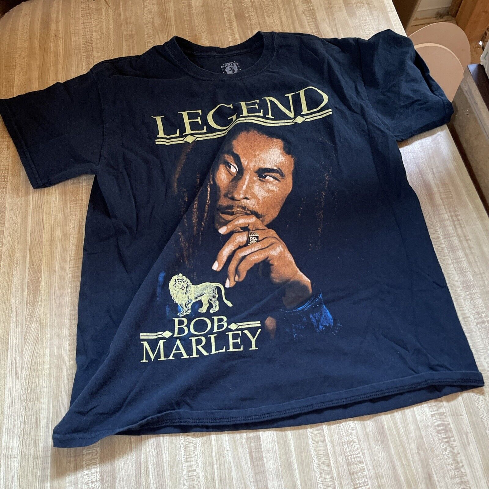 Bob Marley Legend T Shirt in black featuring a portrait of Bob Marley with text Legend and Bob Marley