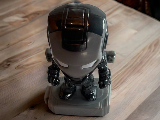 Marvel action figure toy of a black and gray armored hero standing on a gray base on a wooden surface