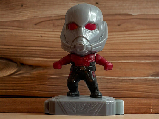 Antman action figure with detailed silver helmet and red suit standing on a gray base