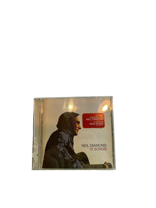 Neil Diamond 12 Songs CD album cover featuring a side profile of Neil Diamond playing guitar