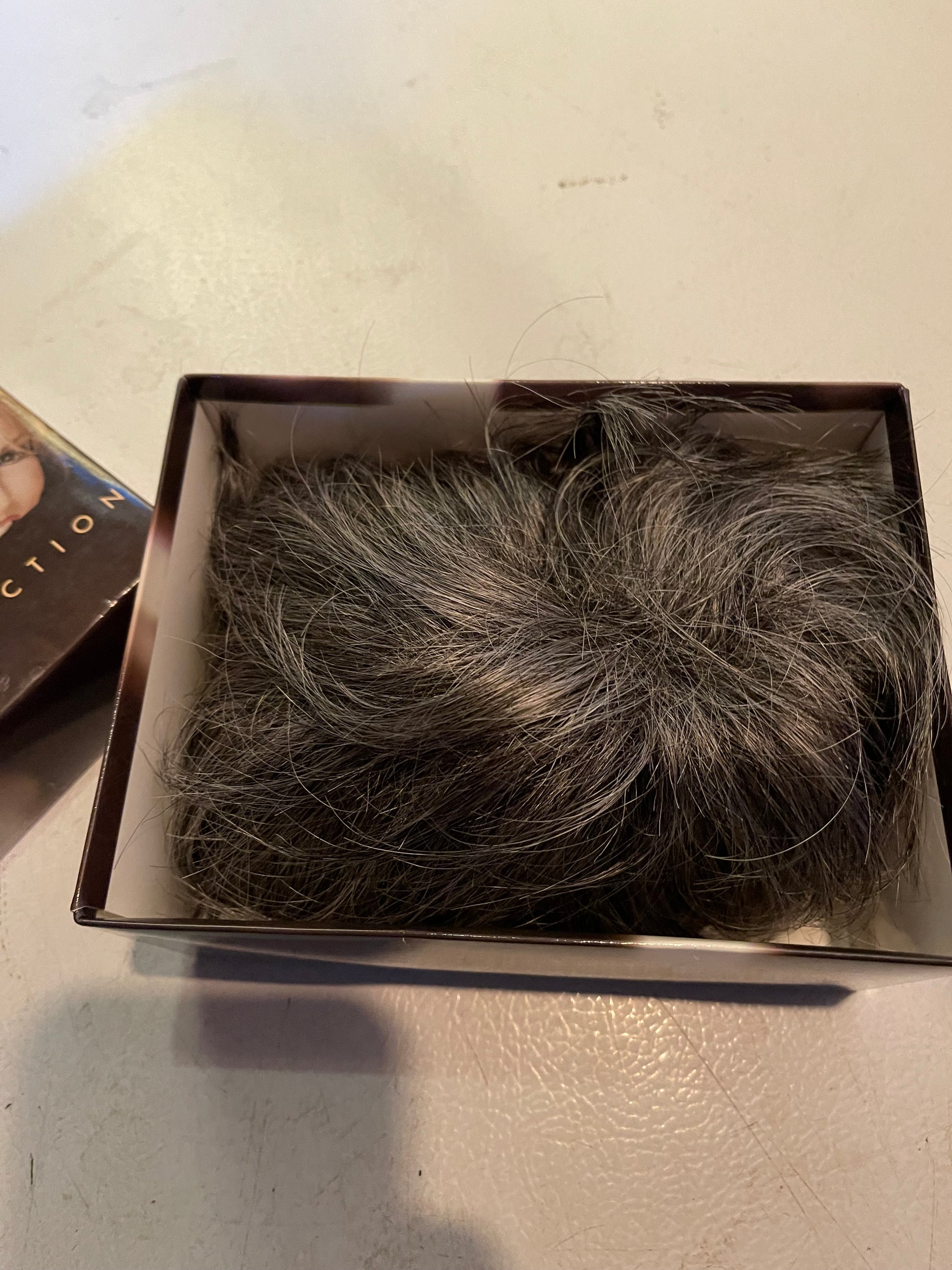 Luxury women’s wigs realistic dark brown with gray highlights in a black storage box