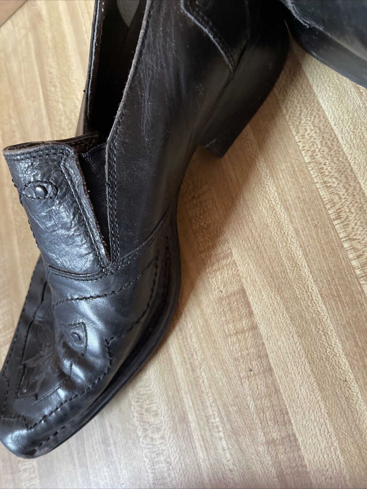 Black leather Back Stage by Skechers shoes with stitched detailing and low heel on wooden floor