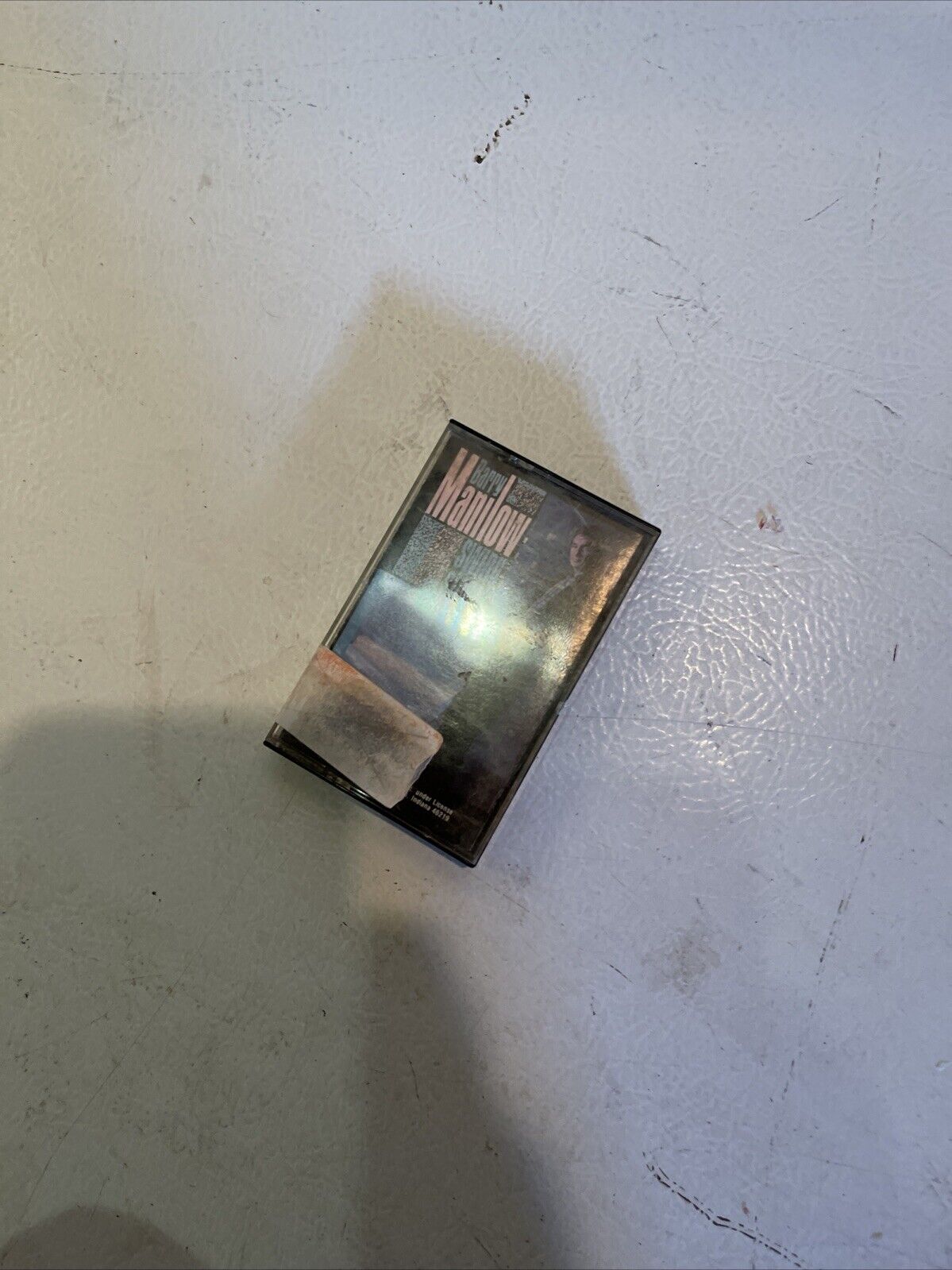 vintage Barry Manilow tape in black case with cover art on a light textured surface