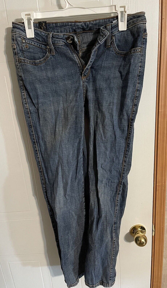 1118 Emporium women's short length jeans in blue denim hanging on white hanger
